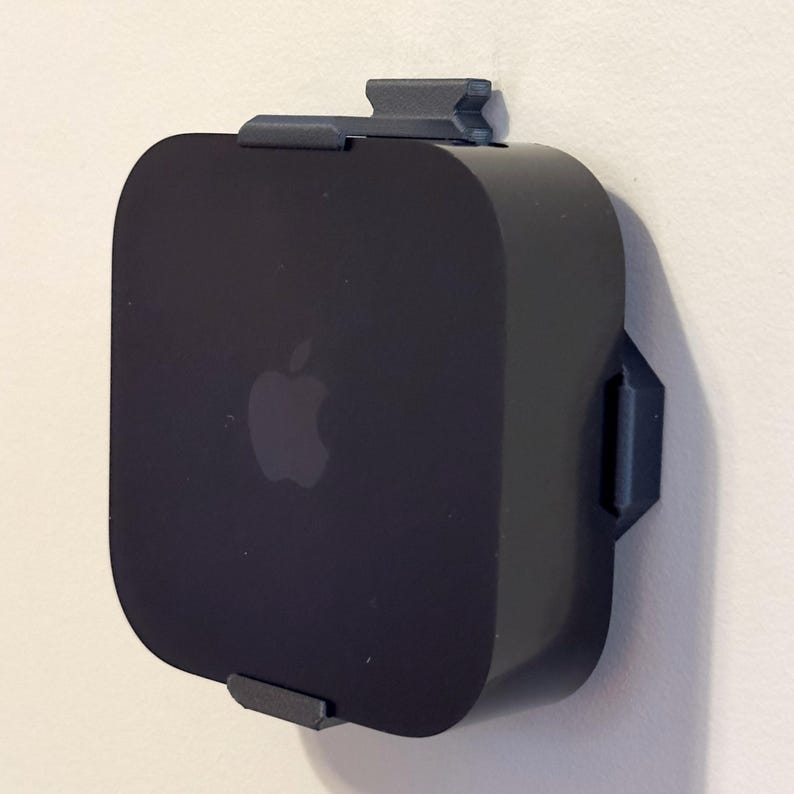 Apple TV 4K 3rd generation secured in a black SPEKURA wall mount